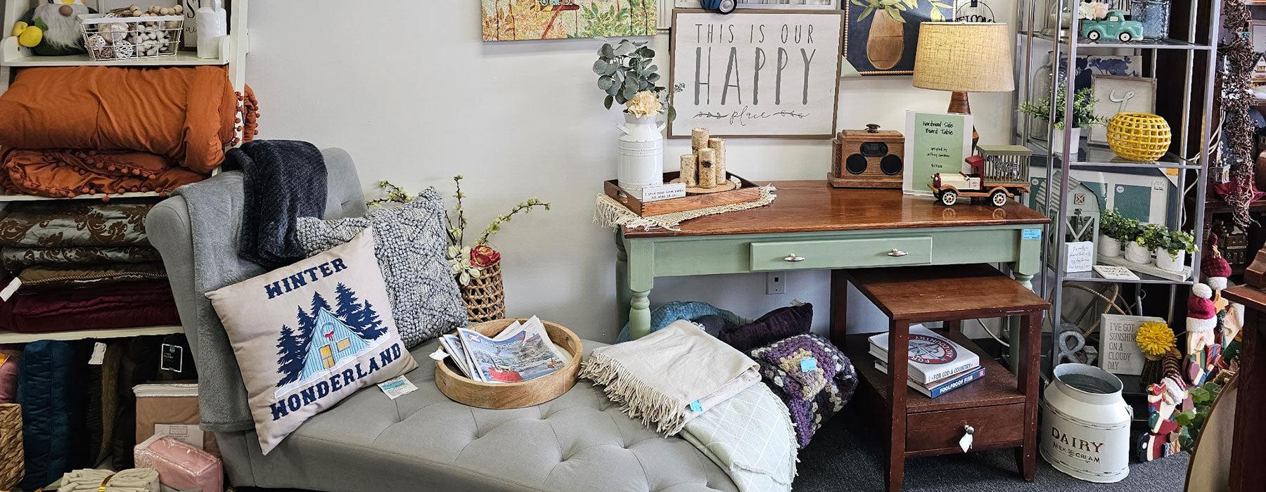 Cozy living room with a sofa, cushions, and a small table with decor items.