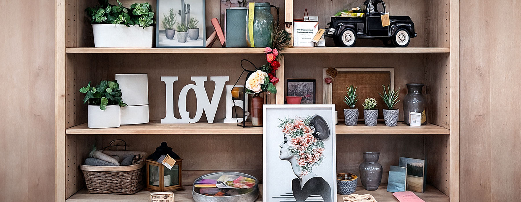 Wooden shelf with decorative items including plants, books, and a 'LOVE' sign.